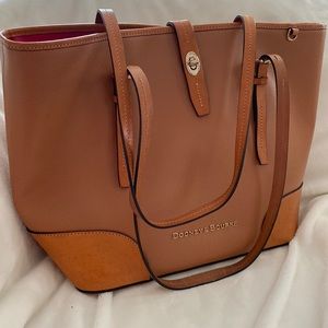 Dooney & Bourke Handbag tore. Excellent condition. Used only a few times.
